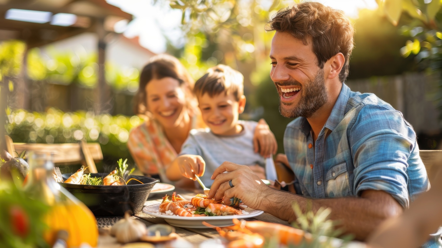 A family having a seafood boil dinner, with a fun, casual setting and plenty of smiles